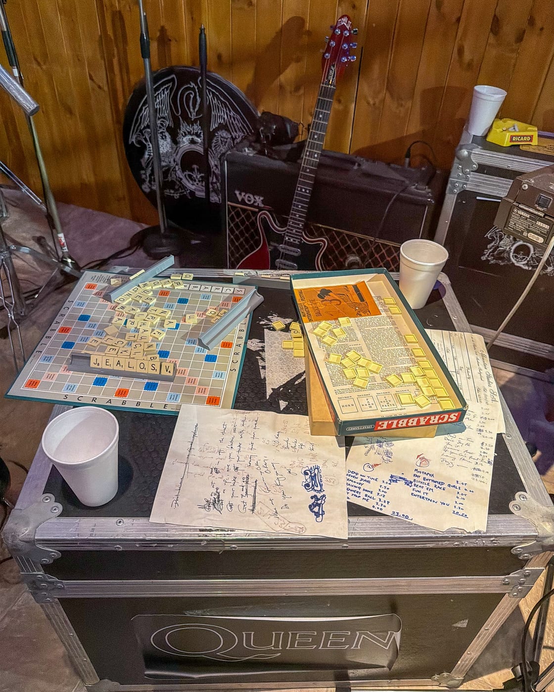 Das Scrabble-Brett der Band und Setlist-Blätter auf einer Queen-Tourneekiste.